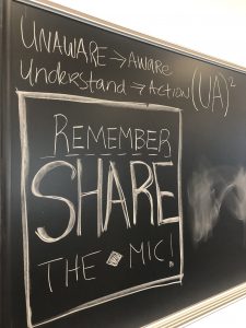 Blackboard from Summer 2019 Institute: "Unaware to Aware; Understand to Action; equals UA squared. Remember to share the mic!"